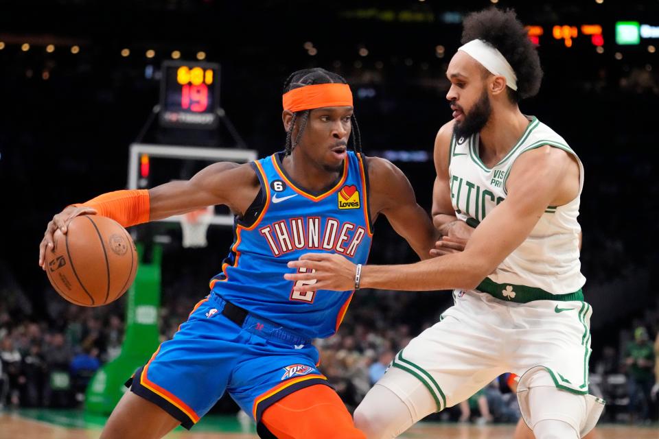 Oklahoma City Thunder guard Shai Gilgeous-Alexander (2) drives to the basket against Boston Celtics guard Derrick White, right, during the first half of an NBA basketball game, Monday, Nov. 14, 2022, in Boston. (AP Photo/Charles Krupa)