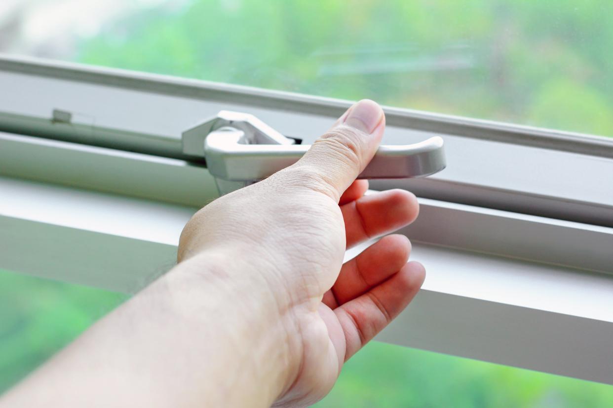 Closeup of hand locking a window