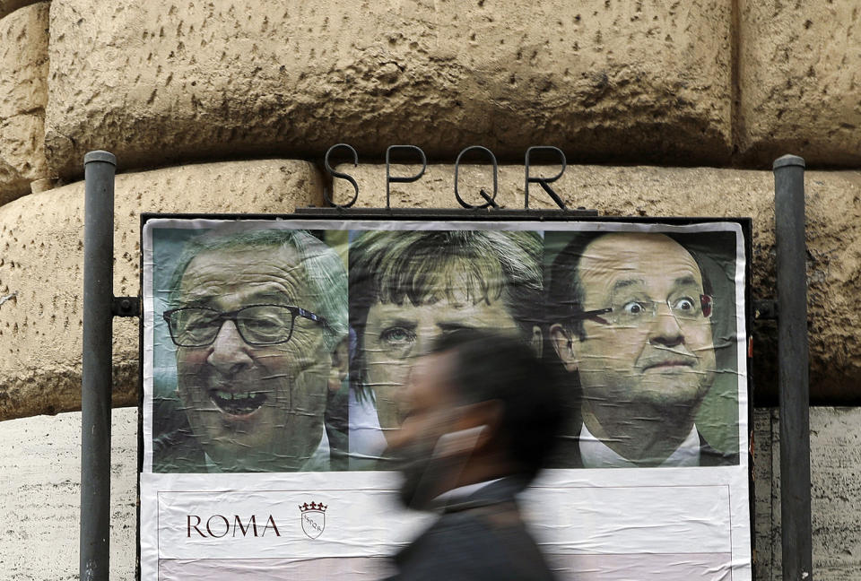 Man walks past poster in Rome