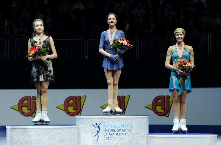 Russia's first placed Evgenia Medvedeva (C) on the podium with second placed Elena Radionova (L) and third placed Anna Pogorilaya, during the European Figure Skating Championships in Bratislava on January 29, 2016