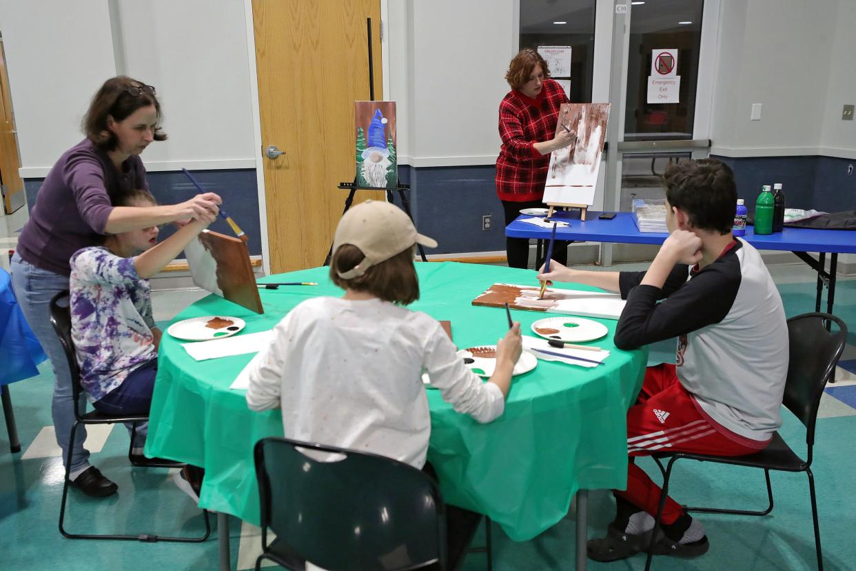 Kim Rathy of Painted Dreams, top, leads children in an Integrated Community Solutions art class at Medina County Board of Developmental Disabilities in Medina.