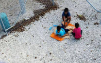 An undated supplied image from Amnesty International claiming to show children playing near a fence at the country's Australian-run detention centre on the Pacific island nation of Nauru. Amnesty International/Handout via REUTERS