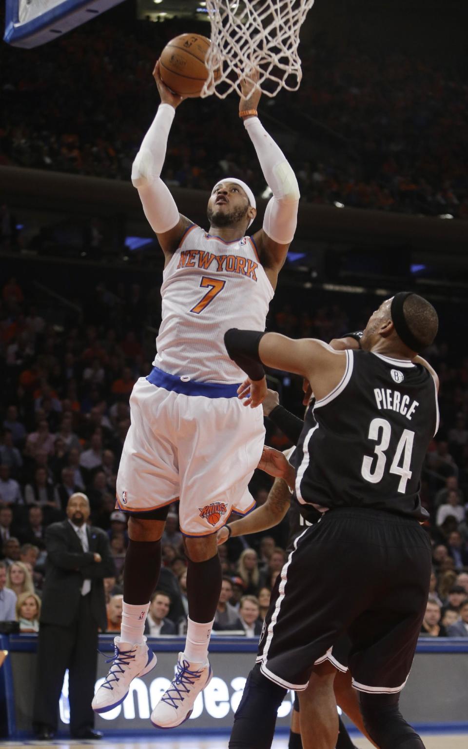 New York Knicks' Carmelo Anthony (7) shoots over Brooklyn Nets' Paul Pierce (34) during the first half of an NBA basketball game Wednesday, April 2, 2014, in New York. (AP Photo/Frank Franklin II)
