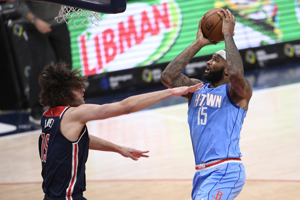 Houston Rockets center DeMarcus Cousins, right, goes to the basket against Washington Wizards center Robin Lopez, left, during the second half of an NBA basketball game, Monday, Feb. 15, 2021, in Washington. (AP Photo/Nick Wass)