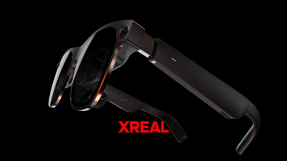 The Xreal Air 2 Ultra floating in front of a black background wqith the word 'Xreal' below them in red