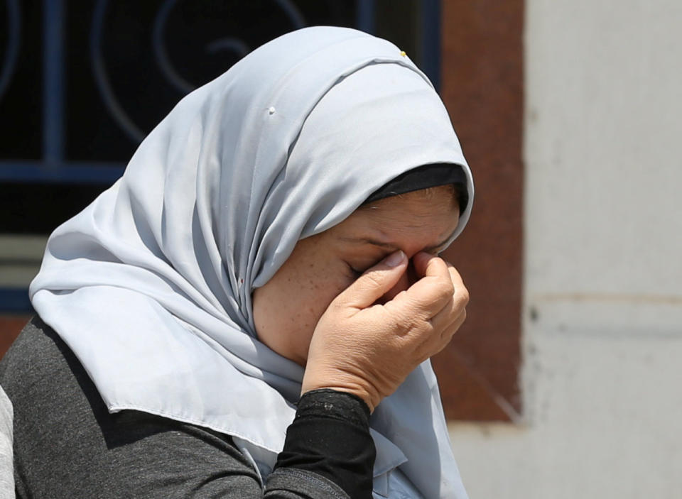 An unidentified woman reacts as she waits outside the EgyptAir in-flight service building, where relatives and friends of passengers who were flying in an EgyptAir plane that vanished from radar en route from Paris to Cairo are being held, at Cairo International Airport, Egypt, May 19, 2016. (Reuters/Mohamed Abd El Ghany)