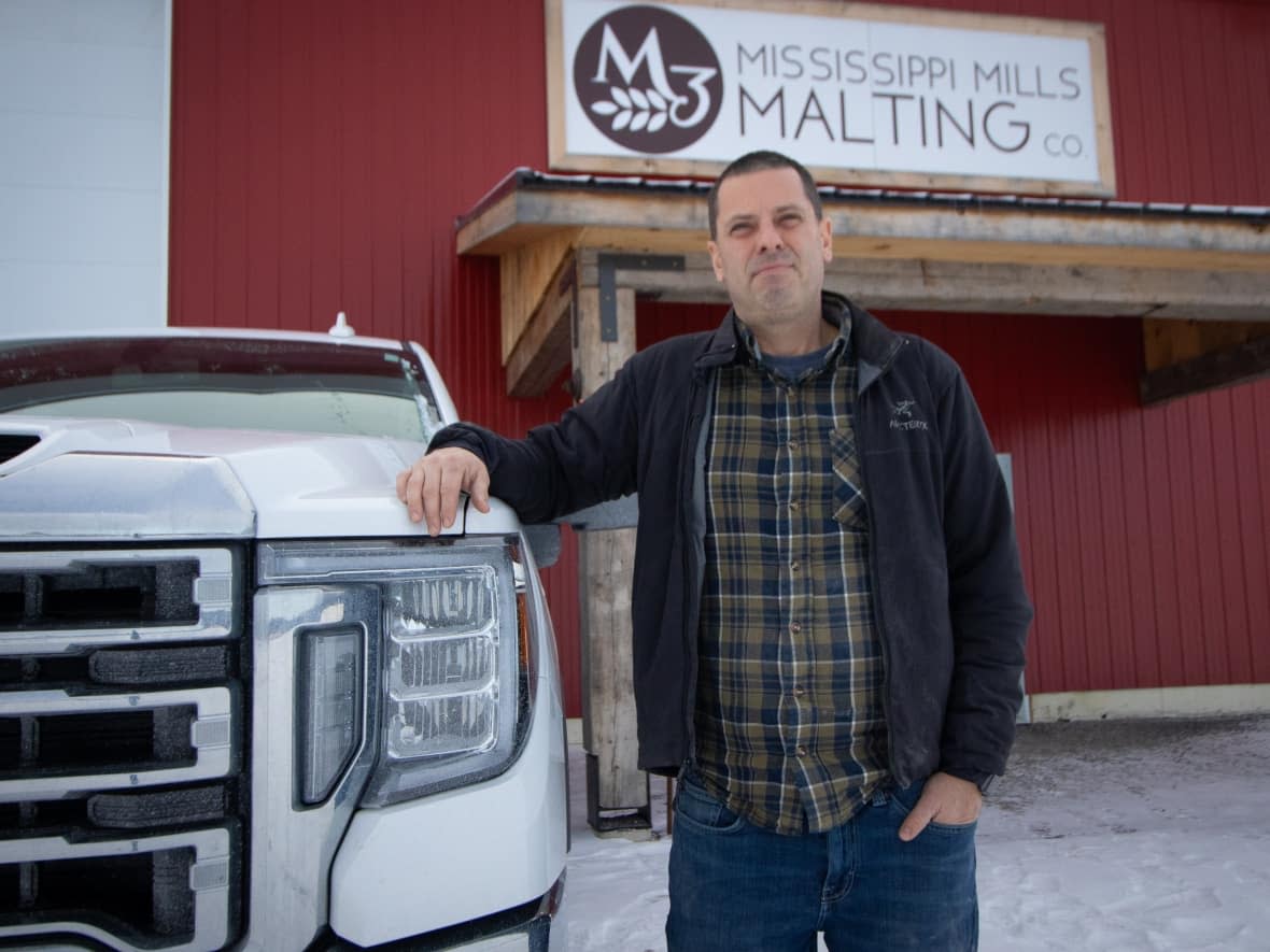 Mississippi Mills Malting co-owner Dean Bowes stands outside his barn in early January. Bowes says it's a good time for Ontario maltsters as last summer's drought in Western Canada and pandemic supply issues have made it harder for brewers and distillers to get the grains they normally use. (Trevor Pritchard/CBC - image credit)