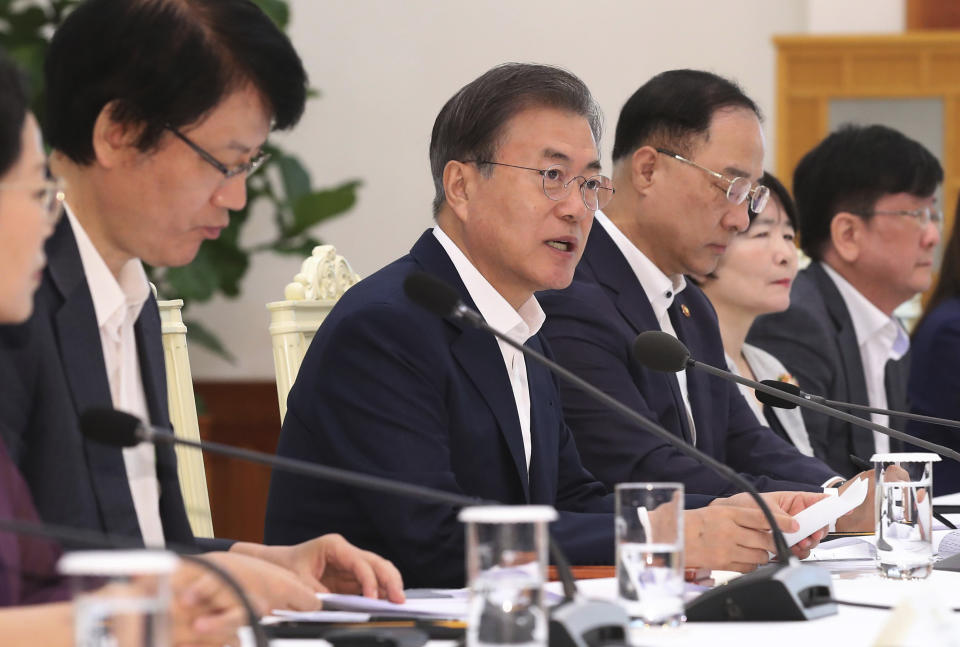 South Korean President Moon Jae-in, third from left, speaks during a meeting with economic advisers to discuss the government's response to Japan's export restrictions on South Korea at the presidential Blue House in Seoul, South Korea, Thursday, Aug. 8, 2019. Japan has granted the first permit for South Korea-bound shipment of chemicals for use in high-tech materials under Tokyo's new export requirement that has increased tensions with Seoul. (Jeon Shin/Newsis via AP)