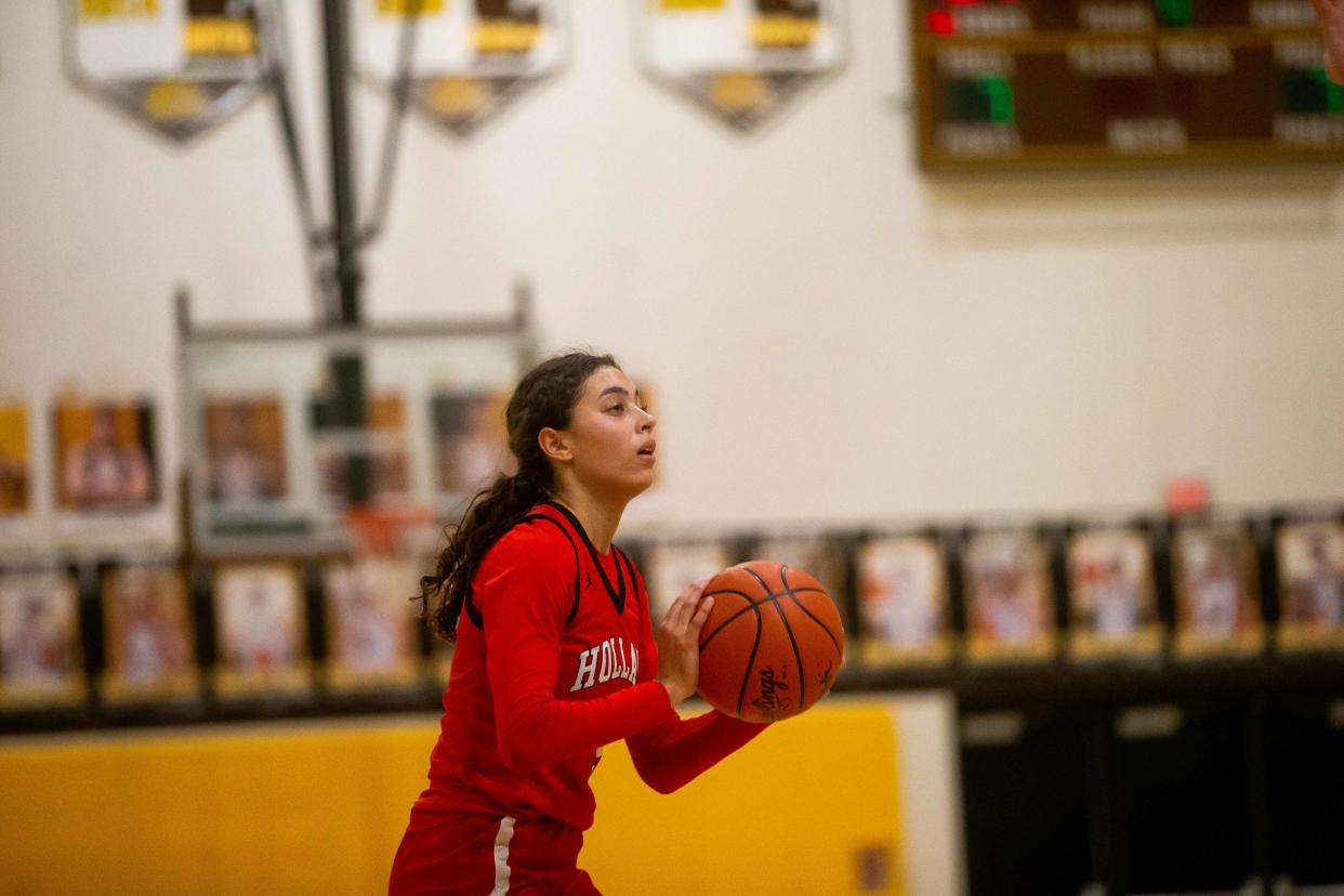 Holland's Ariana Gray lines up a shot against Zeeland East Friday, Jan. 13, 2023, at Zeeland East. 