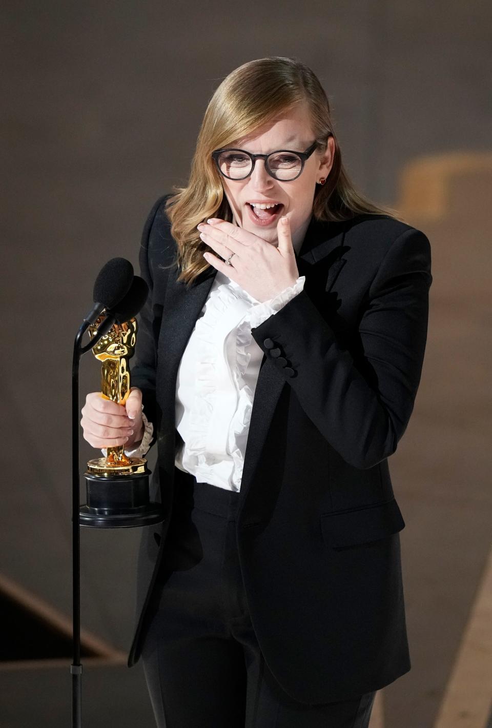 Sarah Polley accepts the award for best adapted screenplay for "Women Talking" .