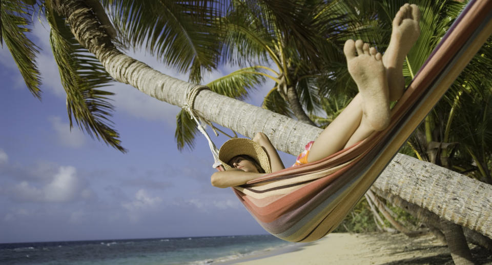 Fiji, Namenalala Island, young woman lying in hammock on beach. Source: Getty Images 