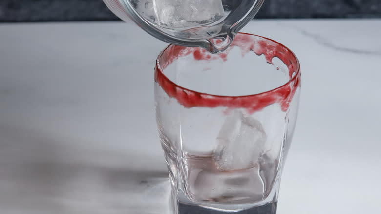 adding ice to cocktail glass