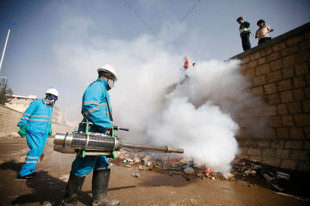 Workers spray pesticides during an anti-cholera campaign in Sanaa, Yemen March 21, 2019. Picture taken March 21, 2019. REUTERS/Mohamed al-Sayaghi