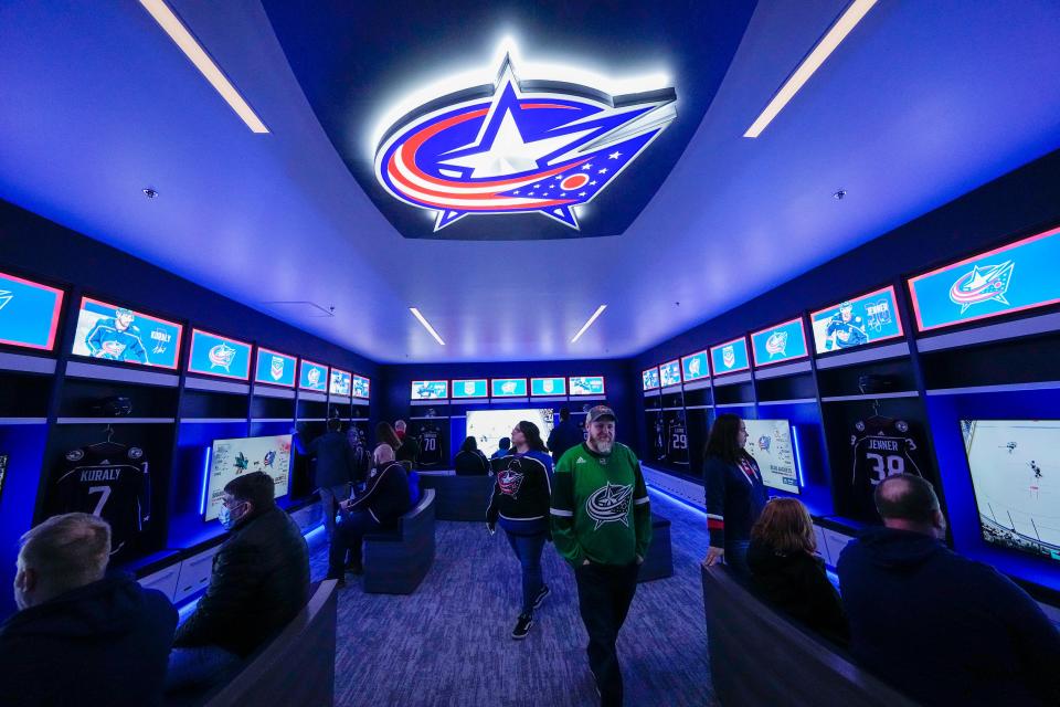 Visitors play NHL23 on XBox stations in the Columbus Blue Jackets' new Fan Zone.