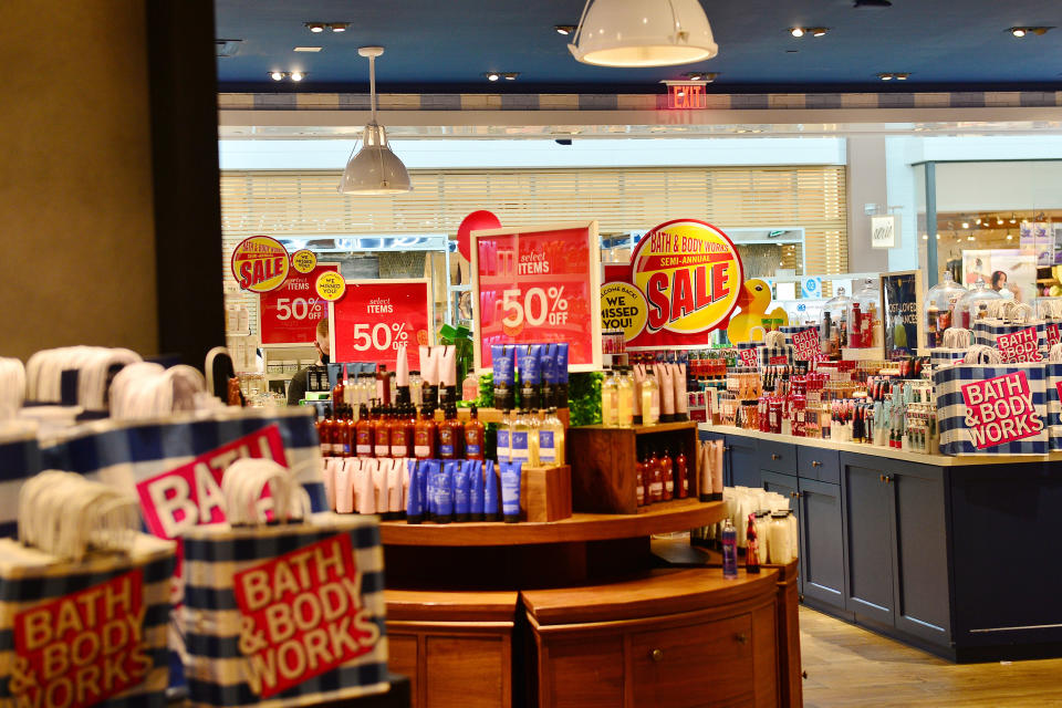 A view inside a Bath and Body Works with several sale signs visible