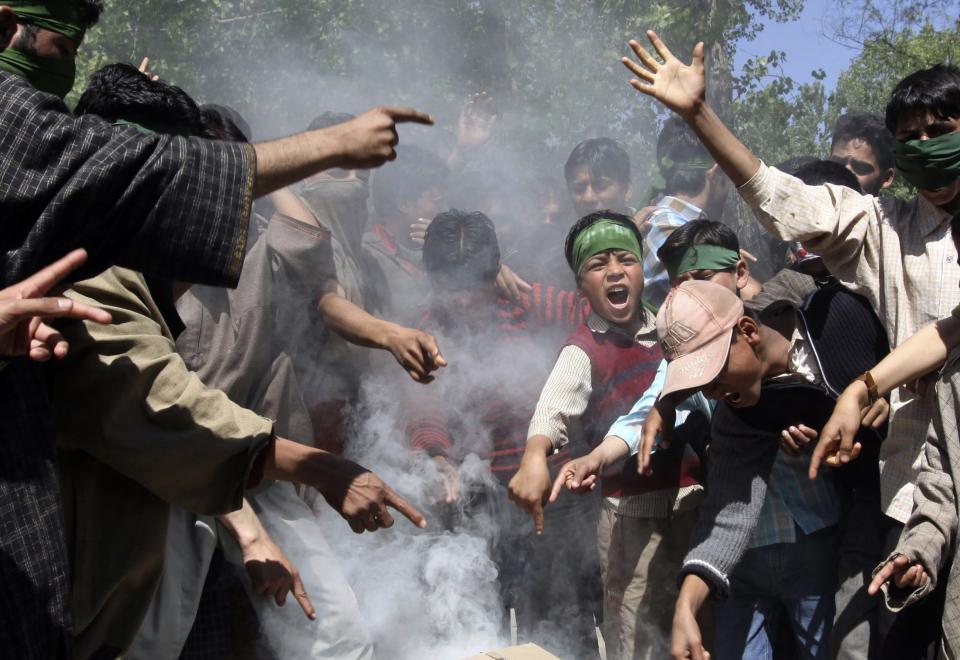 FILE - In this May 13, 2009 file photo, Kashmiri protesters shout freedom slogans near burning tires set up as blockade during a protest against the country’s general elections, in Bomai village, some 65 kilometers (40 miles) north of Srinagar, India. India will hold national elections from April 7 to May 12, 2014 kicking off a vote that many observers see as the most important election in more than 30 years in the world's largest democracy. Boycotts are expected in the violence-wracked northern state of Kashmir where separatist groups have called on the people to shun the elections. In the last parliamentary election in 2009, boycott calls and strikes by separatist rebels in Kashmir were ignored by many, but the state saw only a 40 percent turnout. (AP Photo/Dar Yasin, File)