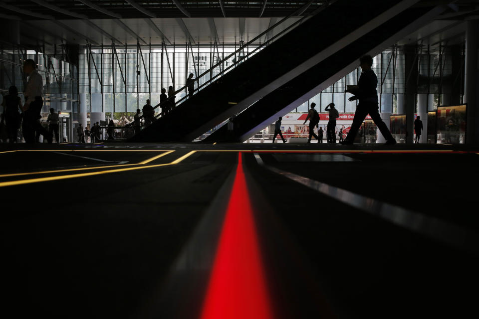 In this June 10, 2019, photo, people walk at the HSBC headquarters at Central, a business district of Hong Kong. It’s still the world’s “freest” economy, one of the biggest global financial centers and a scenic haven for tycoons and tourists, but the waves of protests rocking Hong Kong are exposing strains unlikely to dissipate as communist-ruled Beijing’s influence grows.(AP Photo/Kin Cheung)