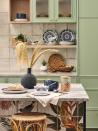 <p>You don't necessarily have to introduce decorative pieces if you want some pattern in a small kitchen. This fabulous central island has been tiled with a cheerful tropical motif, adding colour and pattern to the room without robbing it of valuable space. </p><p>Pictured: <a href="https://direct.asda.com/george/home/tableware/D26M08G08C14,default,sc.html" rel="nofollow noopener" target="_blank" data-ylk="slk:Crockery and accessories, all George at Asda;elm:context_link;itc:0;sec:content-canvas" class="link ">Crockery and accessories, all George at Asda</a></p>