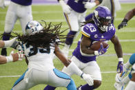 Minnesota Vikings running back Dalvin Cook (33) runs from Carolina Panthers safety Tre Boston, left, during the first half of an NFL football game, Sunday, Nov. 29, 2020, in Minneapolis. (AP Photo/Bruce Kluckhohn)