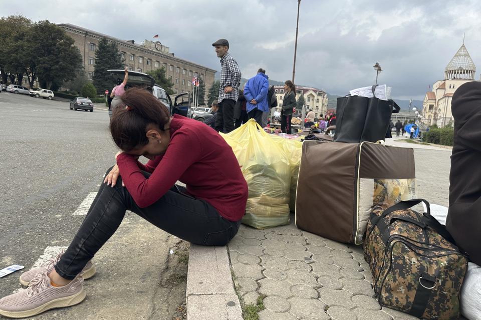 Ethnic Armenians gather in hope to leave Nagorno-Karabakh region for Armenia in the center of Stepanakert, Nagorno-Karabakh, Monday, Sept. 25, 2023. The separatist government of Nagorno-Karabakh announced Thursday that it will dissolve itself and the unrecognized republic will cease to exist by the end of the year, and Armenian officials said more than half of the population has already fled. (AP Photo/Ani Abaghyan)