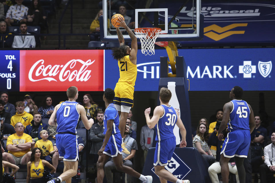 West Virginia guard RaeQuan Battle (21) shoots against BYU during the first half of an NCAA college basketball game Saturday, Feb. 3, 2024, in Morgantown, W.Va. (AP Photo/Kathleen Batten)