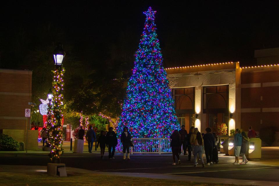 Families look at Christmas tree light display at Glendale Glitters on Dec. 1, 2023.