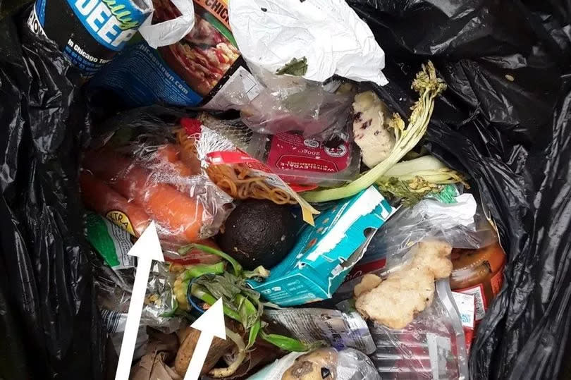 rubbish and recycling in a black bin bag