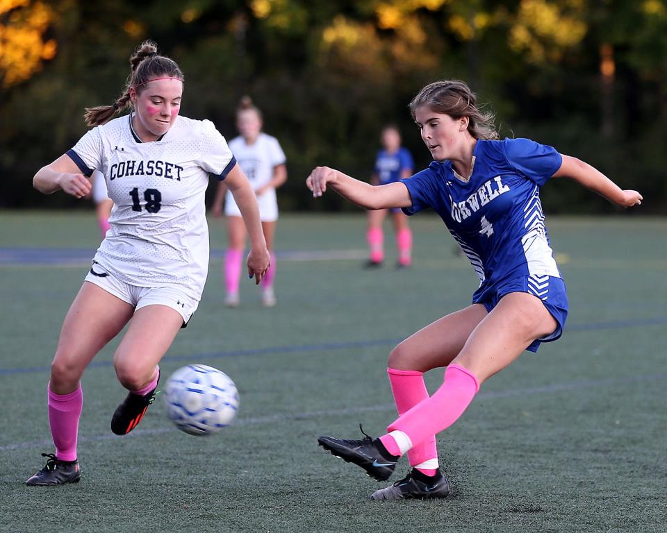 Norwell's Paige Flanders fires a shot on goal while Cohasset's Riley Nussbaum looks to block it during second half action of their game against Cohasset at the Norwell Clipper Community Complex on Tuesday, Oct. 11, 2022.