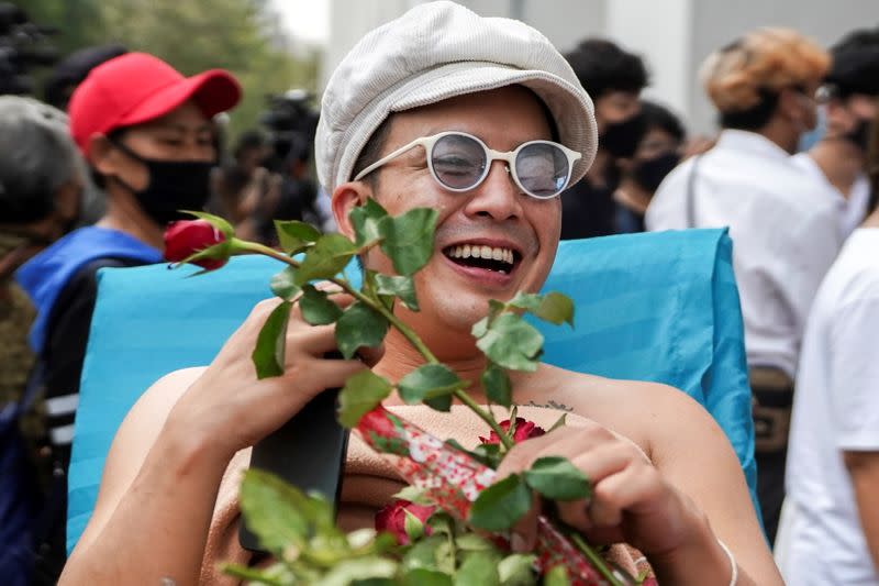 Musician and activist Chaiamorn "Ammy" Kaewwiboonpan arrives to report himself for royal insult charges in Bangkok