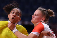 <p>Brazil's centre back Ana Paula Rodrigues Belo (L) is grabbed by Hungary's pivot Reka Bordas during the women's preliminary round group B handball match between Brazil and Hungary of the Tokyo 2020 Olympic Games at the Yoyogi National Stadium in Tokyo on July 27, 2021. (Photo by Daniel LEAL-OLIVAS / AFP)</p> 