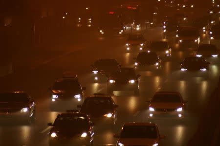 Cars drive in heavy smog during a polluted day in Beijing, China, December 20, 2016. REUTERS/Stringer