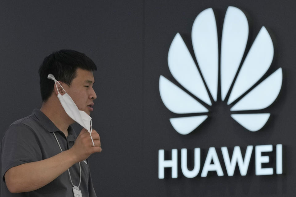 A worker waits for customers inside a Huawei store in Beijing on Wednesday, June 2, 2021. Huawei is launching its own HarmonyOS mobile operating system on its handsets as it adapts to losing access to Google mobile services two years ago after the U.S. put the Chinese telecommunications company on a trade blacklist. (AP Photo/Ng Han Guan)