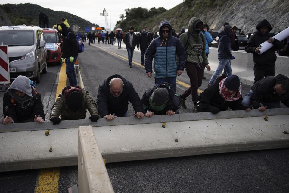 Pro-Catalan independence demonstrators block a major highway border pass near La Jonquera between Spain and France, Monday, Nov. 11, 2019. Protesters following a call to action by a secretive pro-Catalan independence group have closed off both sides of the AP7 highway at the major transportation hub of La Jonquera between France and Spain. (AP Photo/Felipe Dana)