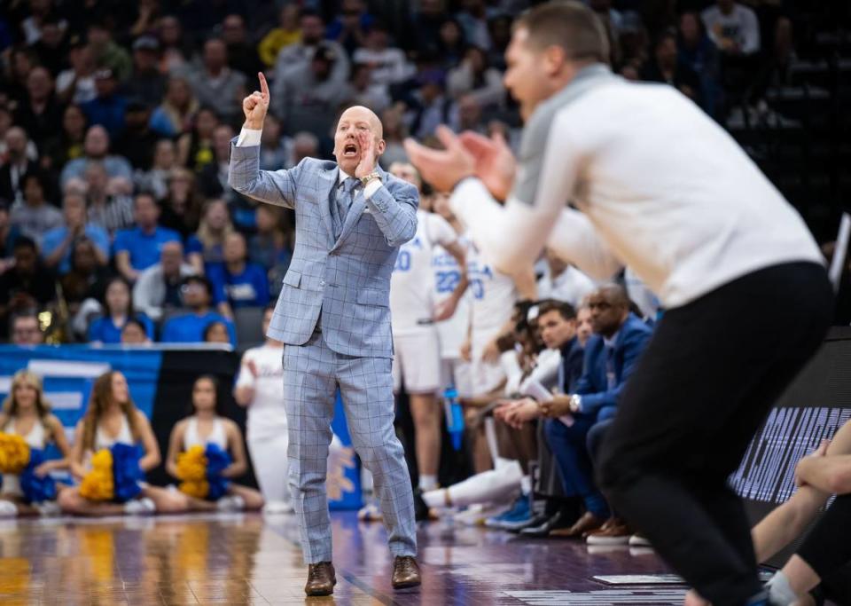 UCLA Bruins head coach Mick Cronin, left, shouts to his players as UNC Asheville Bulldogs head coach Mike Morrell claps at right during the first half of the NCAA Tournament game at Golden 1 Center on Thursday, March 16, 2023, in Sacramento. UCLA beat UNC Asheville, 86-53.