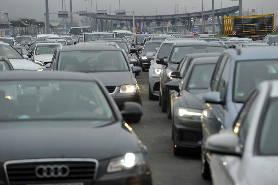 Motorists wait to cross the Croatian border from Slovenia, at Bregana border crossing, western Croatia, Saturday, Dec. 19, 2020. Balkan citizens leaving Western Europe to go home for the holidays created huge traffic jams at border crossings Saturday despite coronavirus restrictions that seek to discourage travel over Christmas and New Year's. Huge lines of cars formed on the borders between Slovenia and Croatia as well as Hungary and Serbia as thousands of people waited for hours Saturday and earlier on Friday to cross. (AP Photo)