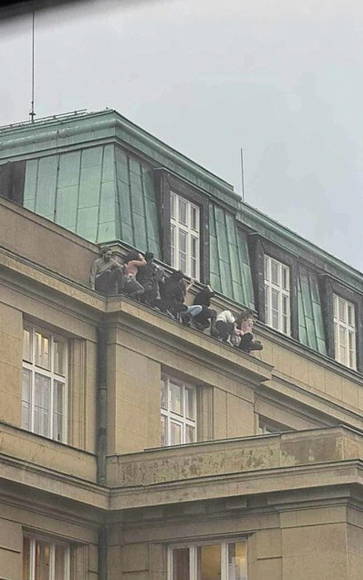 Students hiding on the ledge of a building during the shooting