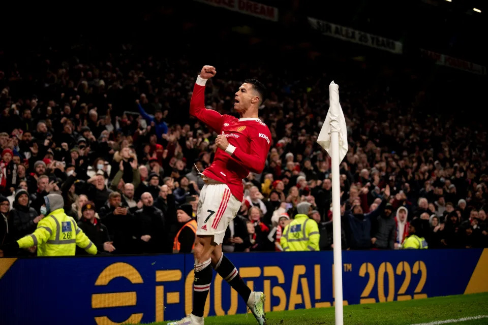 MANCHESTER, ENGLAND - FEBRUARY 15:   Cristiano Ronaldo of Manchester United celebrates scoring a goal to make the score 1-0 during the Premier League match between Manchester United and  Brighton & Hove Albion at Old Trafford on February 15, 2022 in Manchester, England. (Photo by Ash Donelon/Manchester United via Getty Images)