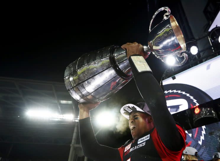 Henry Burris holds up the Grey Cup