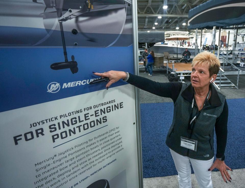 Debbie Priepke, regional business manager for Mercury Marine, shows what occurs underneath the boat when operating the joystick piloting for outboards for single-engine pontoons at the Expo Center at State Fair Park in West Allis.