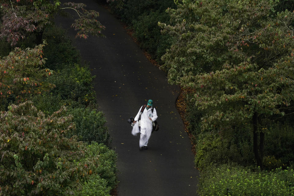 A caddie walks along the sixth hole during the first round of the Masters golf tournament Friday, Nov. 13, 2020, in Augusta, Ga. (AP Photo/Matt Slocum)