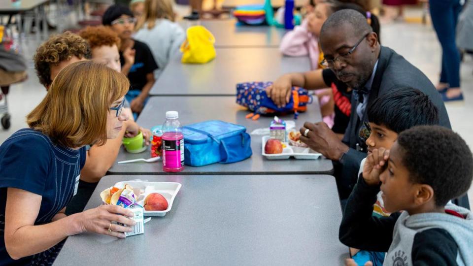 Cindy Long, Administrator of the USDA Food and Nutrition Service, left, and Robert Taylor, Wake County Schools Superintendent, eat lunch with students at Kingswood Elementary in Cary on Tuesday, June 4, 2024. Wake County school administrators briefed the school board Tuesday on a plan to potentially add 28 more schools to the federal government’s universal school meals program.