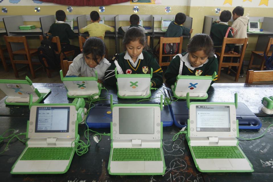 In this June 8, 2012 photo, students use their laptops at the Jose Maria public school in a shantytown on the outskirts of Lima, Peru. Peru has sent more than 800,000 laptop computers children across the country, one of the world’s most ambitious efforts to leverage digital technology in the fight against poverty. Yet five years into the program, there are serious doubts about whether the largest single deployment in the One Laptop Per Child initiative was worth the more than $200 million that Peru’s government spent. (AP Photo/Karel Navarro)