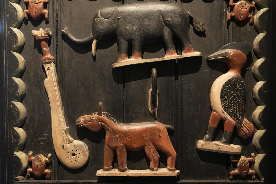 A detail in a dhe door of King Glele 'palace, from Benin 19th century, is pictured at the Quai Branly–Jacques Chirac museum, Monday, Oct. 25, 2021 in Paris. In a decision with potential ramifications across European museums, France is displaying 26 looted colonial-era artifacts for one last time before returning them home to Benin. The wooden anthropomorphic statues, royal thrones and sacred altars were pilfered by the French army in the 19th century from Western Africa. (AP Photo/Michel Euler)