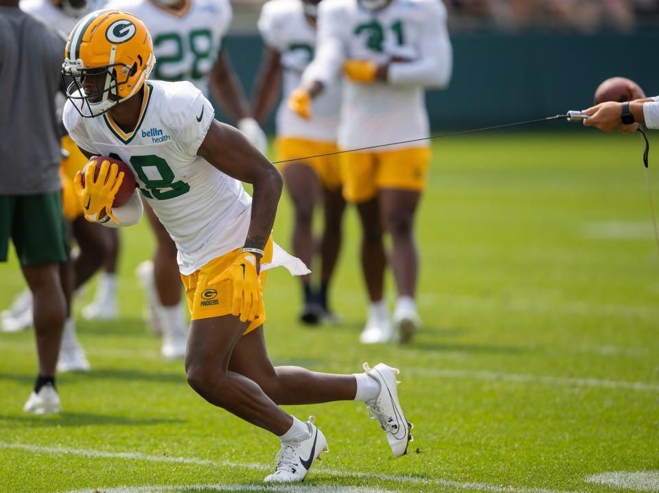 Green Bay Packers wide receiver <a class="link " href="https://sports.yahoo.com/nfl/players/40445" data-i13n="sec:content-canvas;subsec:anchor_text;elm:context_link" data-ylk="slk:Malik Heath;sec:content-canvas;subsec:anchor_text;elm:context_link;itc:0">Malik Heath</a> runs through a ball security drill during practice on Monday, July 31, 2023, at Ray Nitschke Field in Green Bay, Wis.
