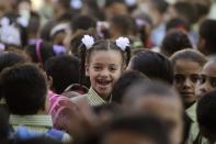 Students line up on the first day of their new school year at a government school in Giza, south of Cairo September 22, 2013. Students resumed their studies at the beginning of the new academic year this weekend amid parental concerns of a possible lack of security after the summer vacation ends. REUTERS/Mohamed Abd El Ghany (EGYPT - Tags: POLITICS EDUCATION)