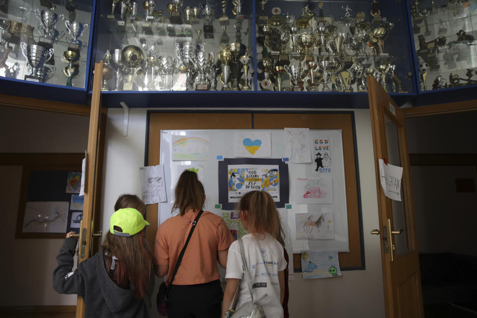 Ukrainian refugee children look at the drawings at the Lauder Morasha Jewish school in Warsaw, Poland, Thursday, July 28, 2022. A special summer camp run by Jewish organizations has brought Jewish volunteers from the former Soviet Union to Warsaw to help Ukrainian children. The camp, which ran for most of July and ended Friday, was organized to bring some joy to traumatized children, help prepare them for the school year ahead in Polish schools and give their mothers some time to themselves. (AP Photo/Michal Dyjuk)