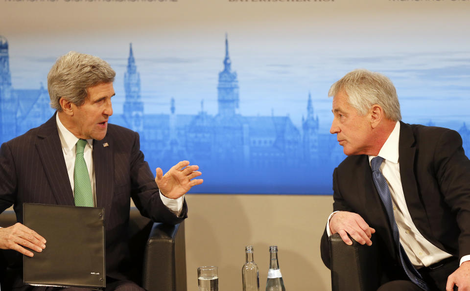 US Secretary of State John Kerry , left, and US Secretary of Defense Chuck Hagel chat during the 50th Security Conference in Munich, Germany, Saturday, Feb. 1, 2014. The conference on security policy takes place from Jan. .31,2014 until Feb. 2, 2014. ( AP Photo/Frank Augstein)