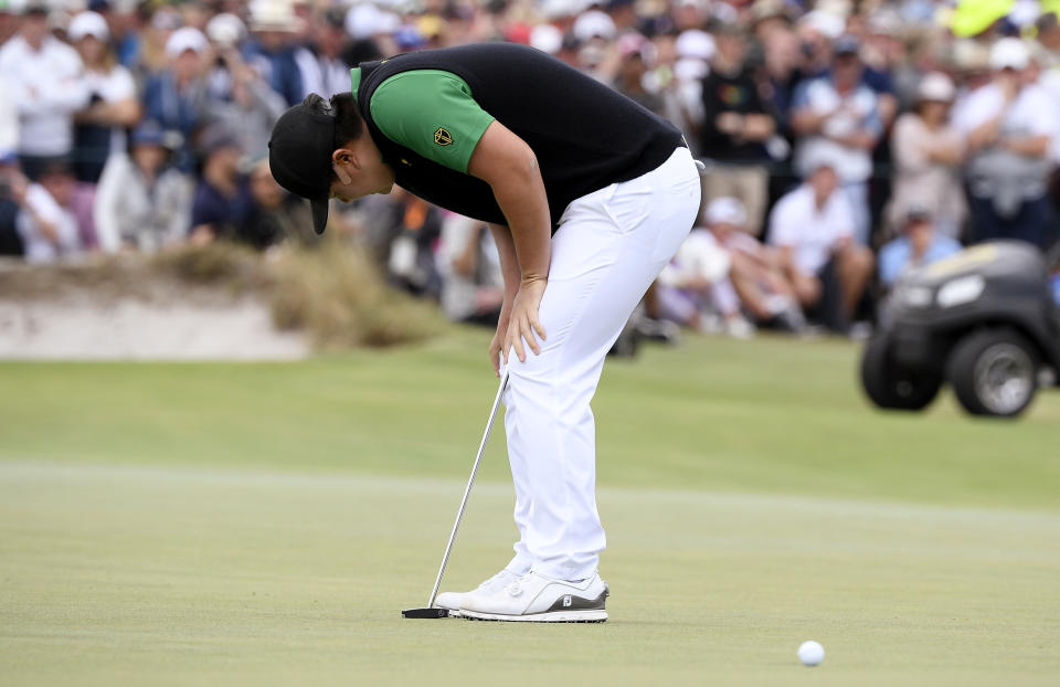 International team player Sung Jae Im of South Korea, bends over after missing a putt on the 18th green in their foursomes match during the President's Cup golf tournament at Royal Melbourne Golf Club in Melbourne, Friday, Dec. 13, 2019. (AP Photo/Andy Brownbill)