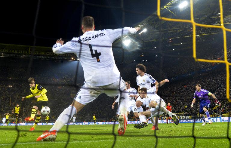 Dortmund's Marco Reus (L) scores during their UEFA Champions League quarter-final, second leg match against Real Madrid, in Dortmund, western Germany, on April 8, 2014