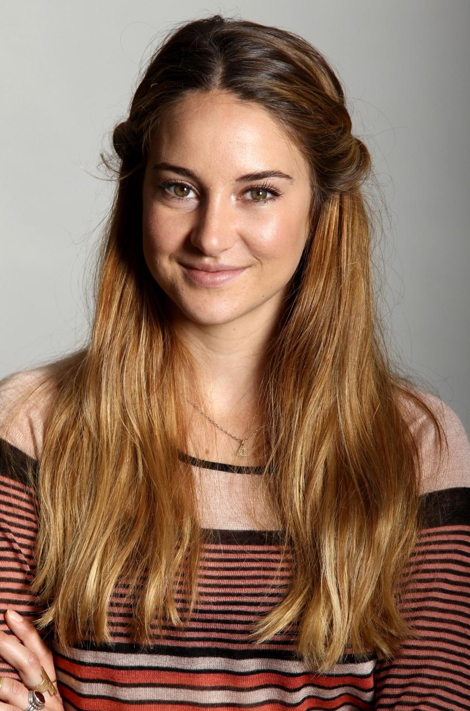 In this Monday, July 29, 2013 photo, actress Shailene Woodley poses for a portrait while promoting her new film "The Spectacular Now" at the Four Seasons Hotel in Los Angeles. She plays the lead in “Divergent,” the big-screen adaptation of the young-adult novel that’s been compared to “The Hunger Games.” And if it’s as popular as predicted when it hit theaters next year, Woodley may have to leave her anonymity behind. (Photo by Matt Sayles/Invision/AP)